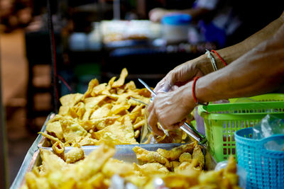 Cropped hand of man preparing food