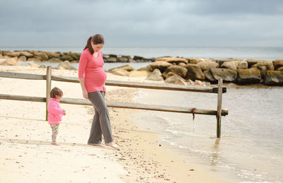 Rear view of woman standing on beach