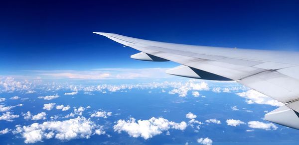 Aerial view of airplane flying in sky