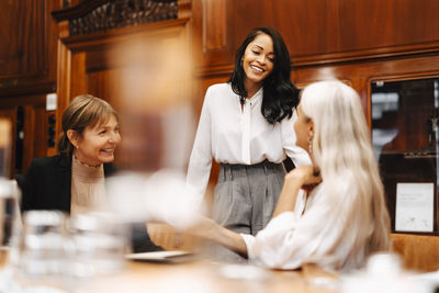 Happy female financial advisors discussing at office