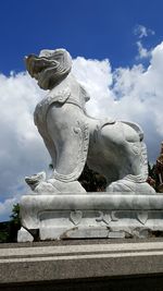 Low angle view of statue against cloudy sky