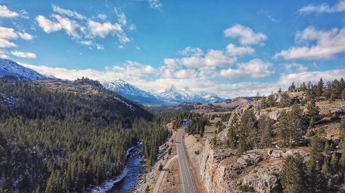 Panoramic shot of road by mountains against sky