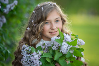 Portrait of cute girl with pink flower