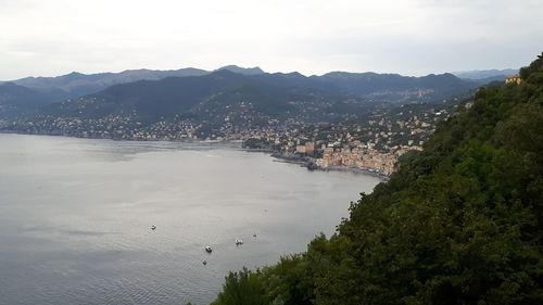 High angle view of city by sea against sky