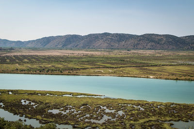 Scenic view of lake and mountains against clear sky