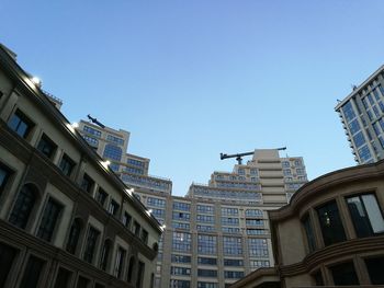 Low angle view of skyscrapers against clear sky