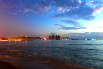 Scenic view of sea against cloudy sky at sunset