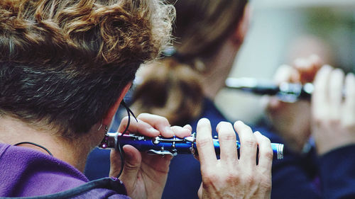 Close-up of men playing flutes