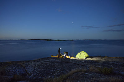 View of tourists camping at sea