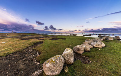 Rocks at sea shore against sky at oland