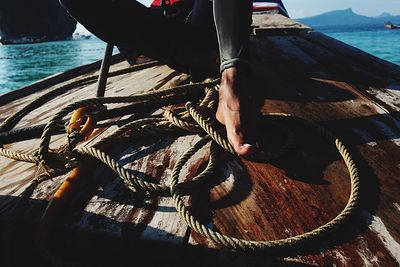 Low section of man fishing in sea