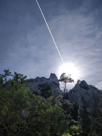 Low angle view of vapor trails against sky