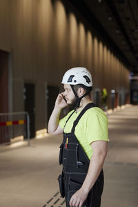 Worker using cell phone at building site