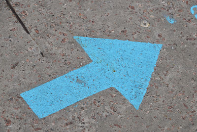 Detail shot of arrow sign on ground