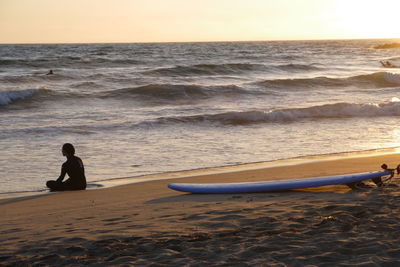 Scenic view of beach against sky during sunset