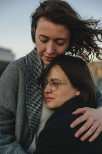 Young woman embracing lesbian partner