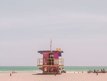 Lifeguard hut on beach against sky