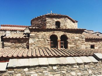 Low angle view of old building against blue sky