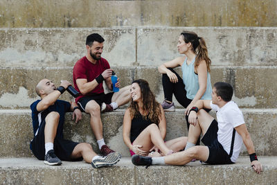 Group of athletes sitting relaxed after practicing crossfit.