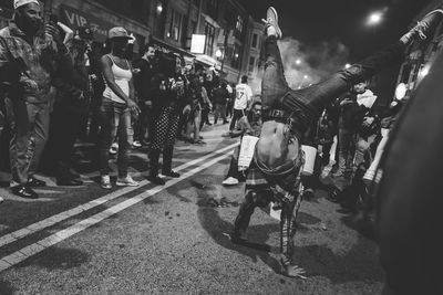 People on street in city at night