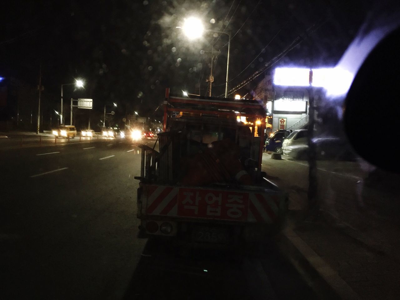 illuminated, night, lighting equipment, street light, transportation, street, light - natural phenomenon, mode of transport, dark, road, outdoors, land vehicle, incidental people, electric light, glowing, car, city, no people, built structure, sky