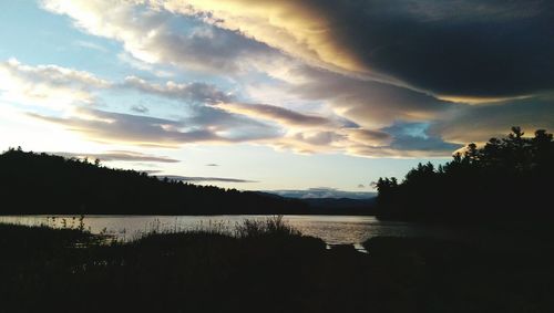 Scenic view of calm lake at sunset