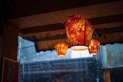 Low angle view of illuminated lanterns hanging in building