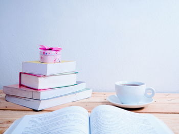 Coffee cup on table against wall