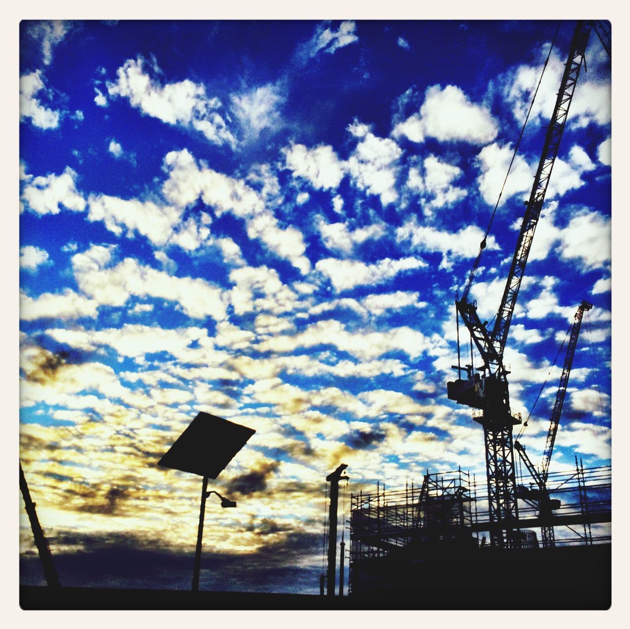 transfer print, low angle view, sky, cloud - sky, auto post production filter, silhouette, cloud, cloudy, blue, street light, sunset, built structure, outdoors, nature, power line, no people, connection, sunlight, day, dusk