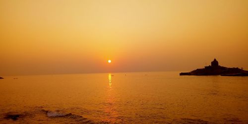 Scenic view of sea against orange sky