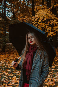 Woman standing in autumn leaves