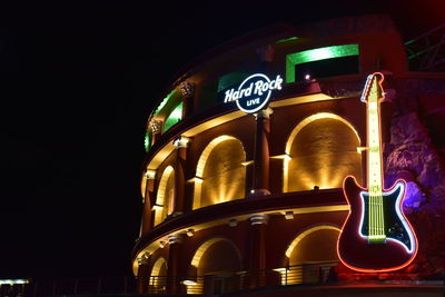 Low angle view of illuminated building at night