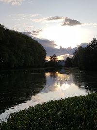 Scenic view of lake against sky at sunset