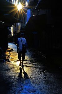 Full length of woman walking on street at night