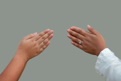 Close-up of couple kissing against white background