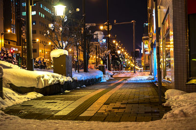 Illuminated city street at night