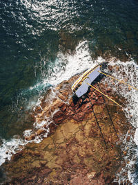 Overhead view of abandoned sailboat on shore