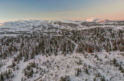 Scenic view of snowcapped mountains against sky during sunset