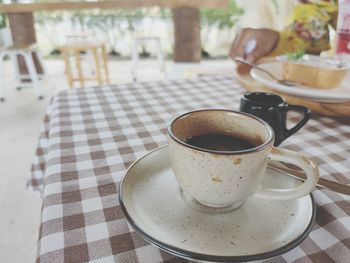 Coffee in a glass placed on a square table