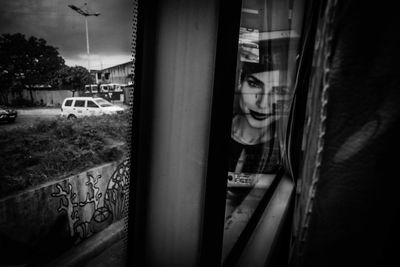 Close-up of man on car window