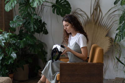 Young girl hold vr glasses prepare to enjoy augmented reality at home garden to relax after work