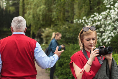 People photographing against sky