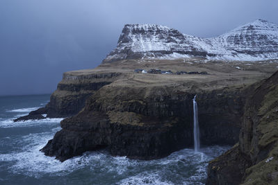 Scenic view of sea and mountains against sky