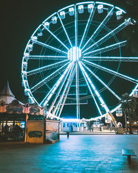 Illuminated ferris wheel at night