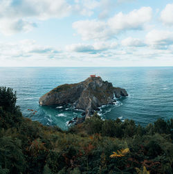 Scenic view of island in sea against sky