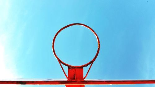 Close-up of basketball hoop against blue sky