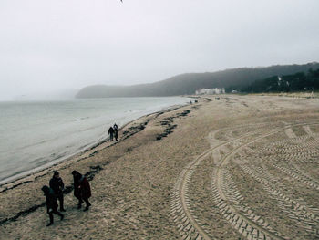 High angle view of people at beach against sky