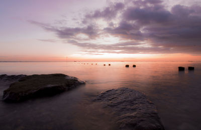 Scenic view of sea against sky at sunset