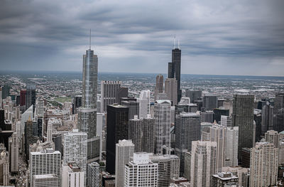 Aerial view of modern buildings in city against sky