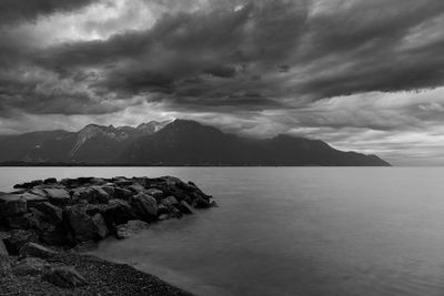 Scenic view of sea and mountains against sky